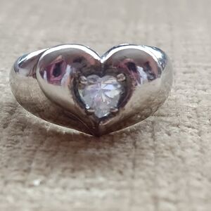 Silver Ring with a Heart Design Featuring a Sparkling Rhinestone Centerpiece.